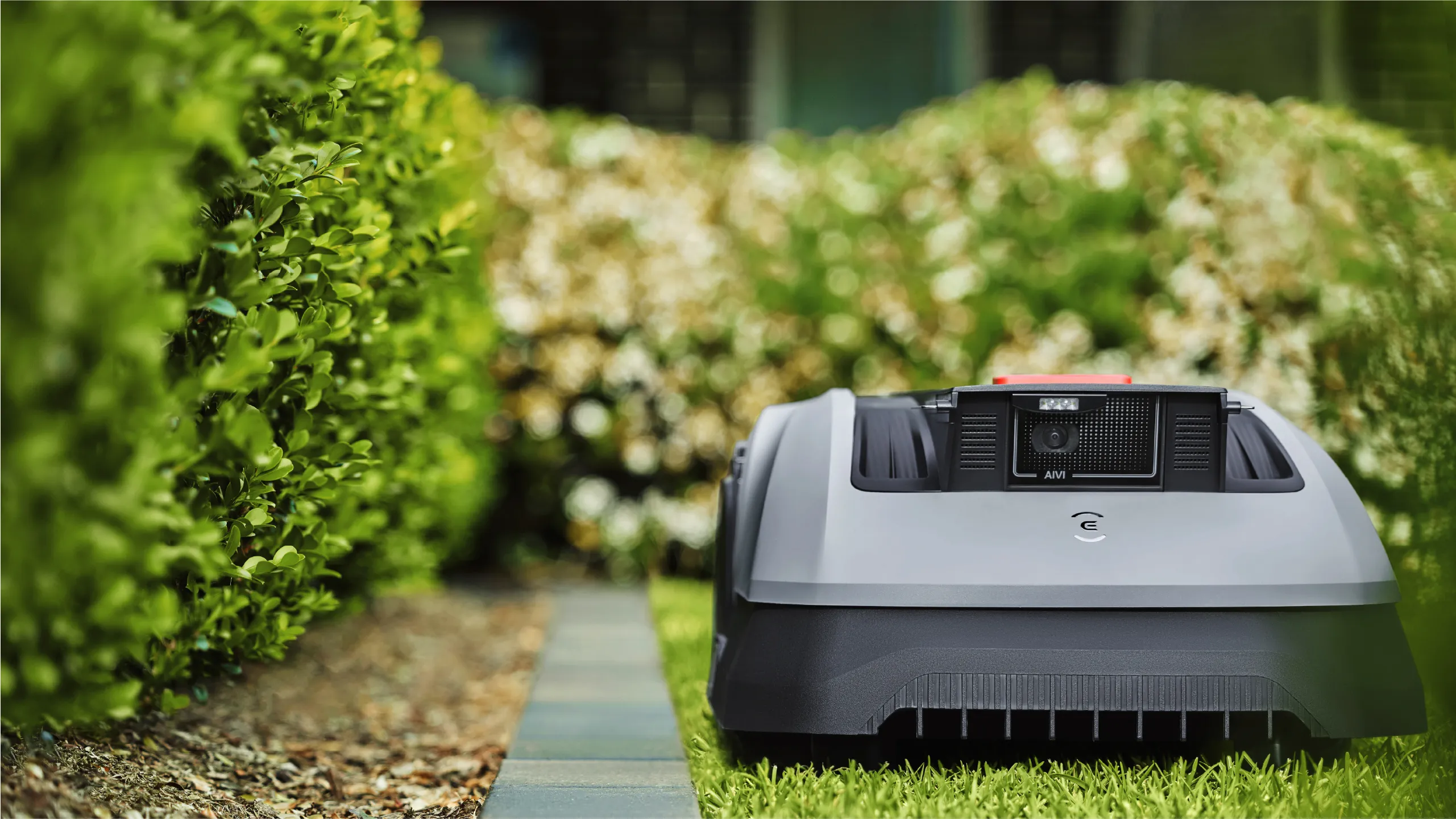 ECOVACS GOAT O600 RTK at a lawn edge with visible front camera