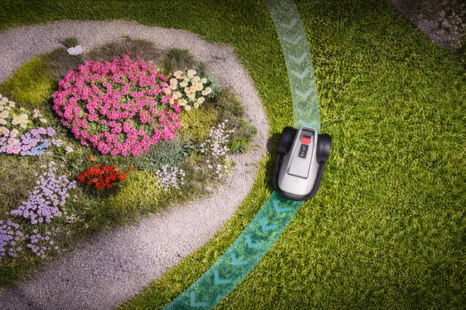 eufy robotic lawnmower drives along a lawn edge around a flower bed