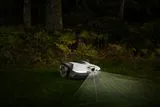 Husqvarna Automower with AI Vision mowing at dusk